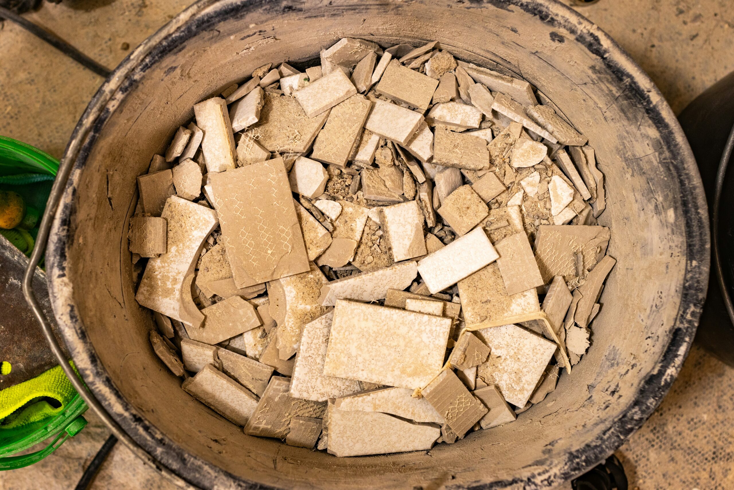 a bucket of tile waste to be sent for ceramic recycling