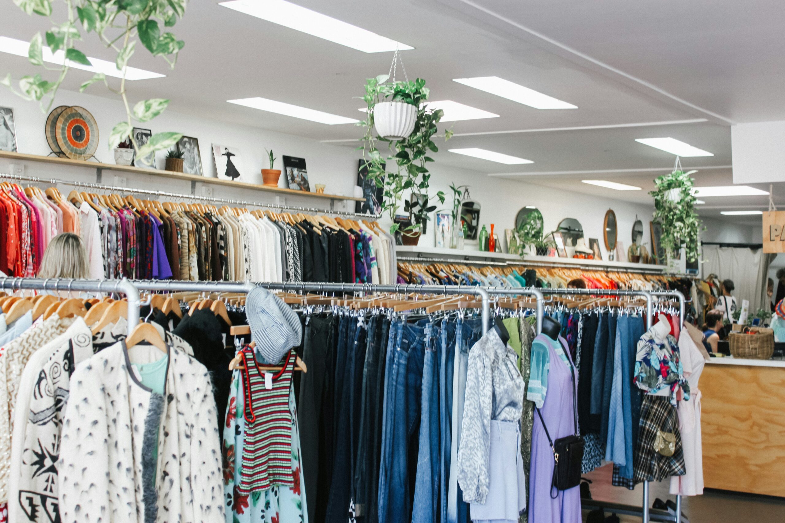 rails of clothes that may require charity waste disposal if not sold