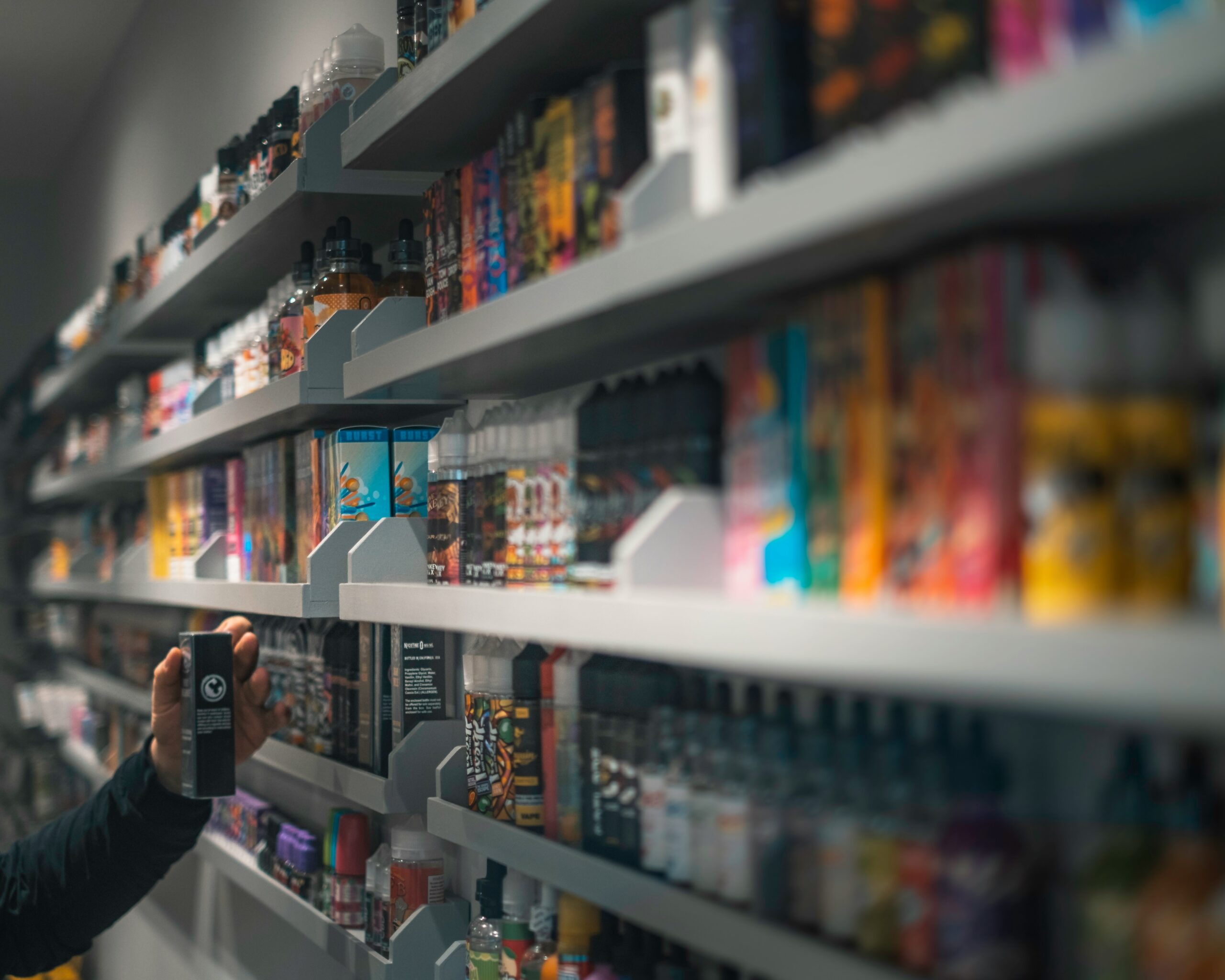 A number of elqiuids and vape kits on a shop shelf that will need to go for vape recycling if not sold