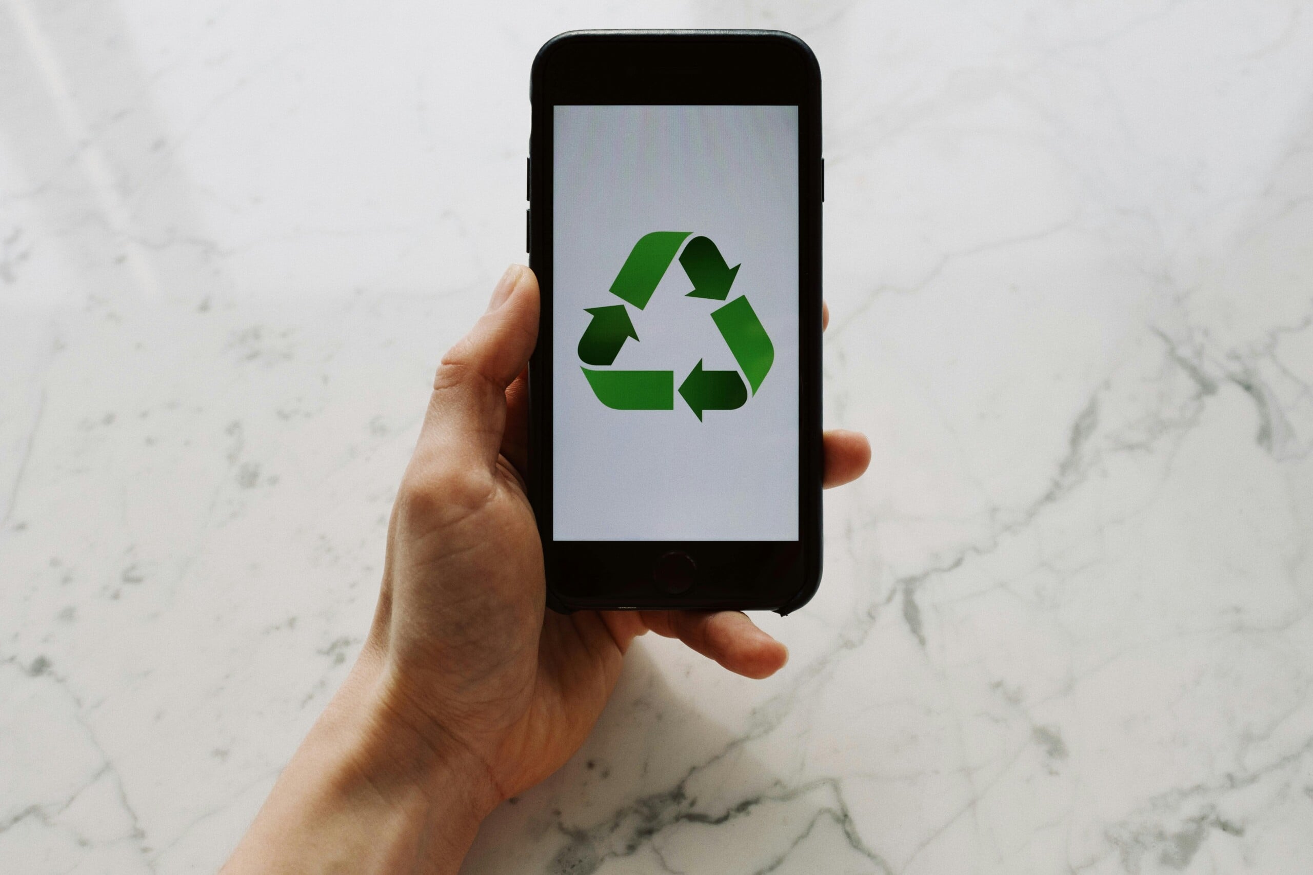 A recycling symbol on an iPhone screen