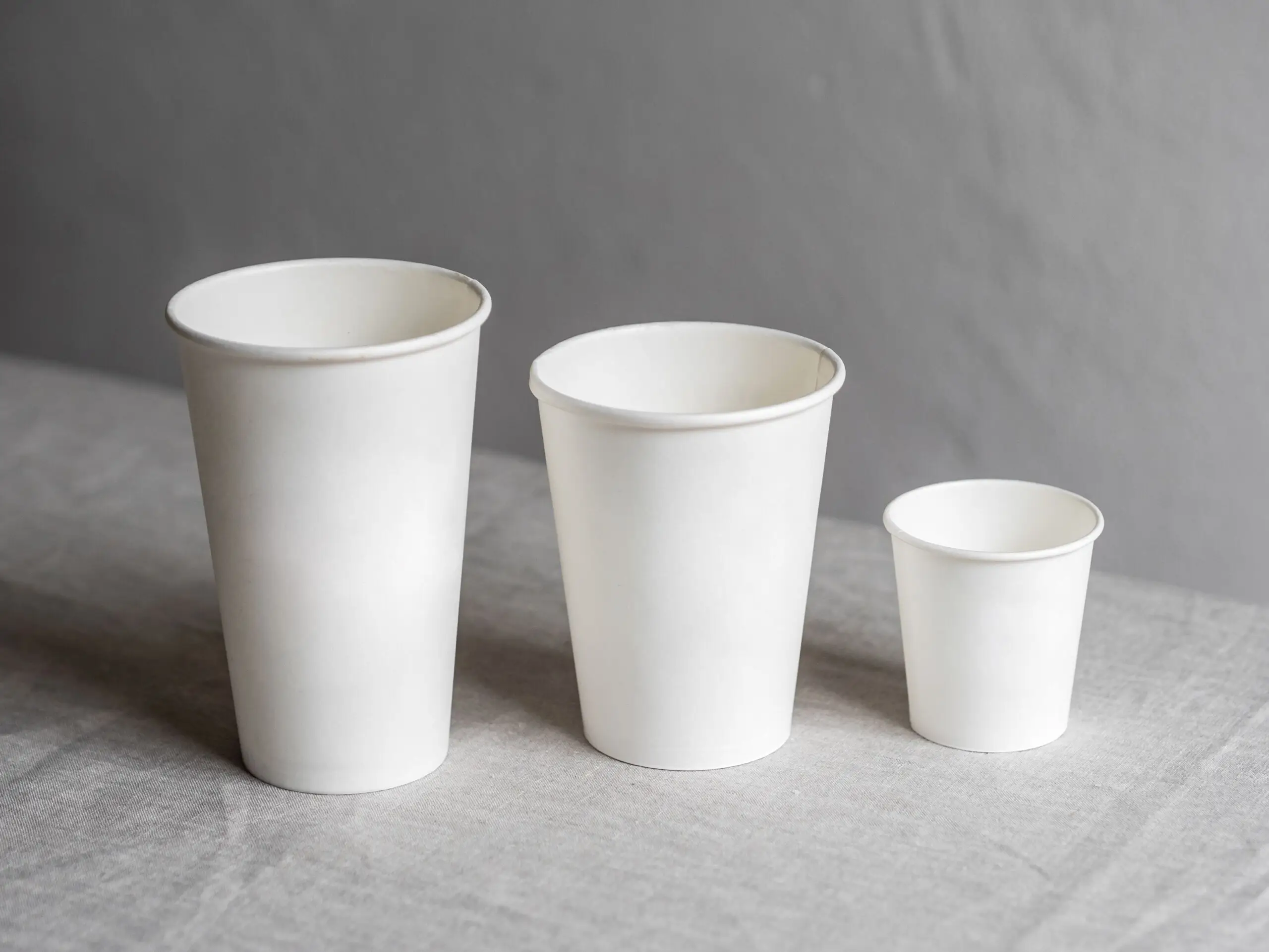 Three paper cups in a row